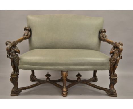 Unusual 19th Century Continental walnut two seat sofa, the upholstered back and overstuffed seat covered in grey leather, the