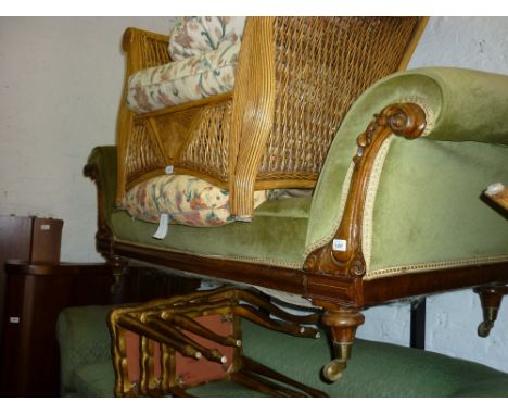 Victorian carved walnut and green upholstered sofa on turned supports with brass casters