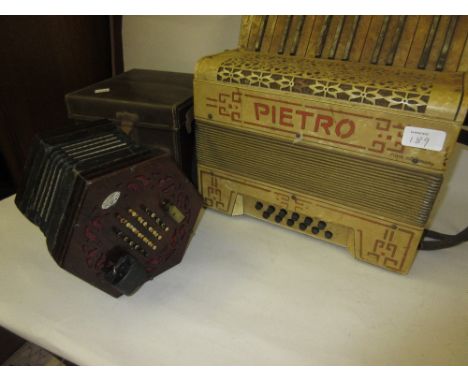 Lachenal and Co. twenty four button concertina in an associated box together with a Pietro German made accordion (a/f)