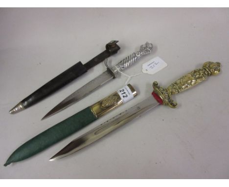 19th / early 20th Century dagger with a cast brass grip and green leather scabbard together with another small dagger