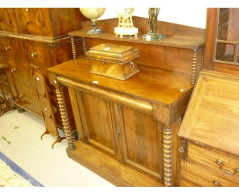 Victorian mahogany chiffonier with an arched shelf back above single drawer and two panelled doors flanked by spiral columns 