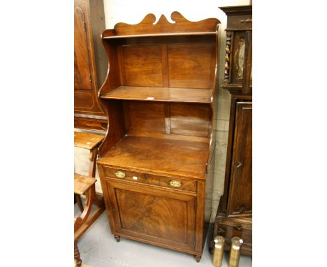 George III mahogany and line inlaid narrow bookcase cabinet, the three shelf waterfall top above a single drawer with oval br