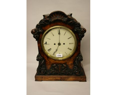 Victorian figured walnut bracket clock, the shaped case with applied carved floral decoration, the circular painted dial with