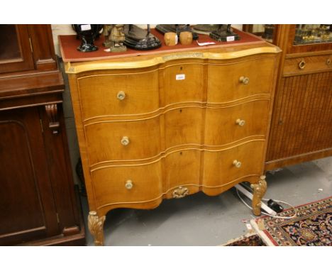 Pair of Continental satin birch serpentine fronted commode chests, each with a carved and moulded tray top above three short 