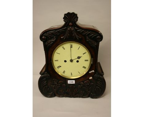 Victorian mahogany bracket clock, the shaped case with applied carved floral decoration, the circular painted dial with Roman