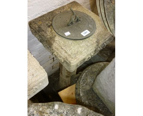 Weathered cast concrete sundial having decorative column support with band of classical figures on a stepped base
