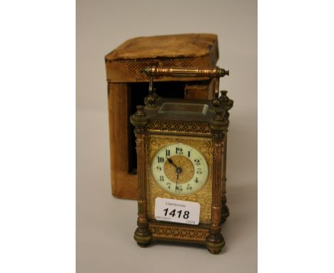 Small late 19th or early 20th Century French brass cased carriage clock, the gilt floral relief decorated dial with a circula
