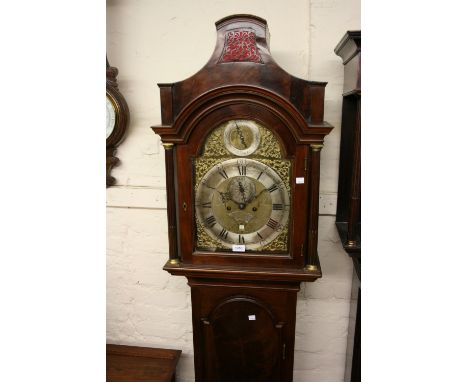 George III mahogany longcase clock, the arched hood above an arched panelled door and a rectangular plinth with bracket feet,