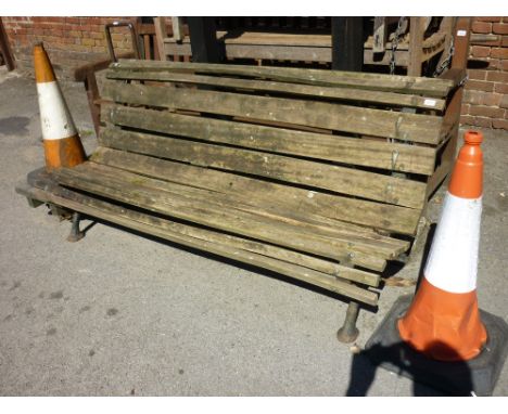 Victorian cast iron and wooden slatted garden bench on naturalistic supports
