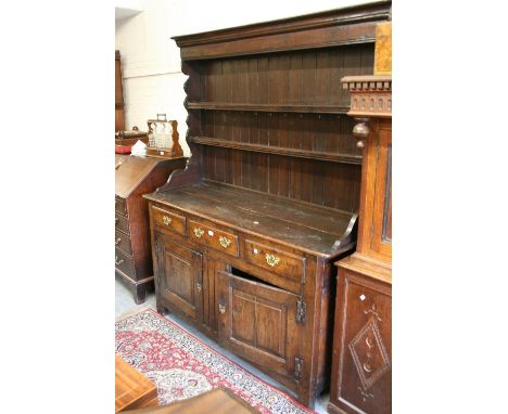 18th Century oak dresser, the boarded shelf back above three drawers and two fielded cupboard doors