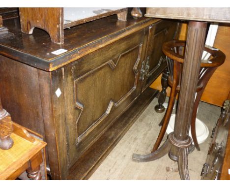 Early 20th Century oak dresser with a boarded shelf back above two panelled doors raised on bun feet