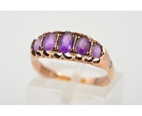 AN EDWARDIAN 9CT GOLD AMETHYST RING, designed as a row of five graduated oval cut amethysts, with a 9ct hallmark for Birmingh