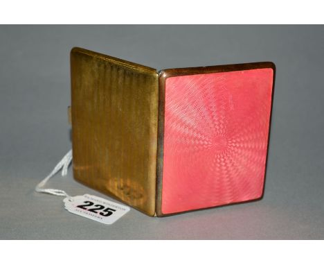 A GOLD PLATED AND PINK ENAMEL CIGARETTE CASE, engine turned decoration back and front, gilt interior, lacks elastic strap
