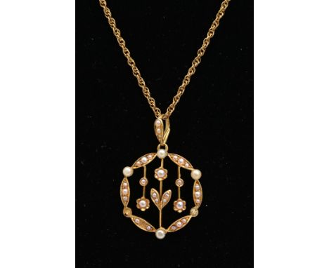 AN EDWARDIAN 15CT GOLD SPLIT PEARL PENDANT ON A LATER 9CT GOLD CHAIN, the circular pendant of openwork design with floral det