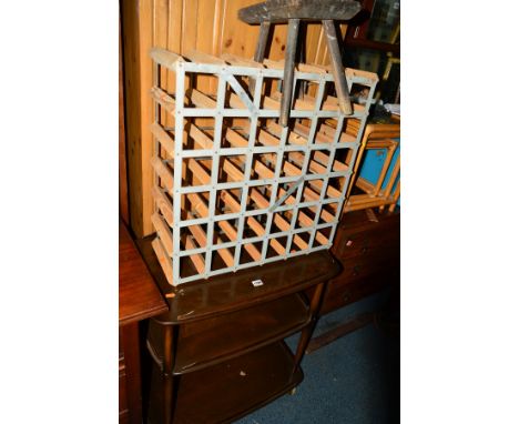 A DARK ERCOL ELM THREE TIER TEA TROLLEY, a 19th Century oak milking stool and a wine rack (3)