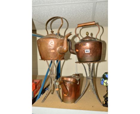 COPPER KETTLE WITH ACORN FINIAL, with second copper kettle, copper watering can (a/f) and two copper trivetts on cast iron tr