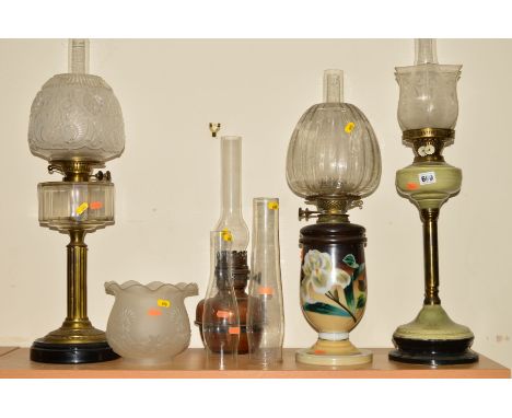 FOUR OIL LAMPS AND LOOSE to include a brass twin burner oil lamp having faceted glass reservoir and pressed glass shade, a mi