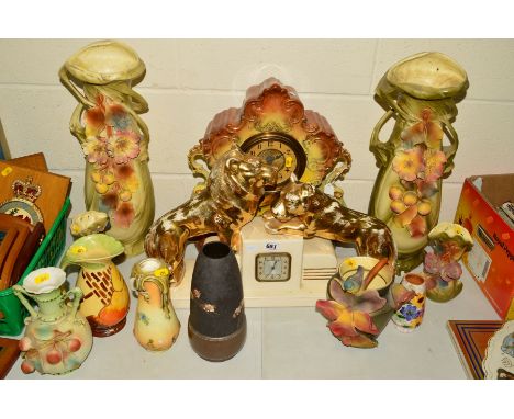 TWO CERAMIC MANTEL CLOCKS, to include a continental Deco style stepped form, with two lions atop, Arabic dial, height 35cm x 