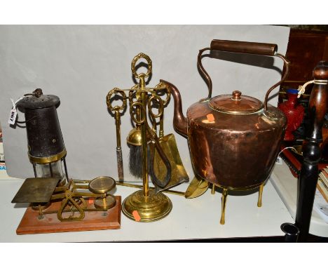 A MINERS LAMP, a set of weighing scales and weights, a brass ladle, brass fireside companion set on stand, copper kettle on b