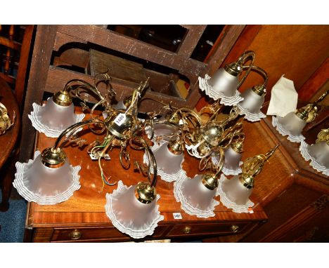 A BRASSED SEVEN PIECE LIGHTING SET, with wavy glass shades, comprising of a twin branch table lamp, five and a three branch c