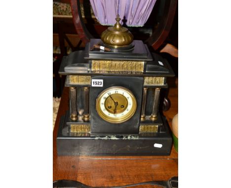 A LATE VICTORIAN SLATE MANTEL CLOCK, brass mounts of slavery, pair of fluted columns flanking an enamel dial with Arabic nume