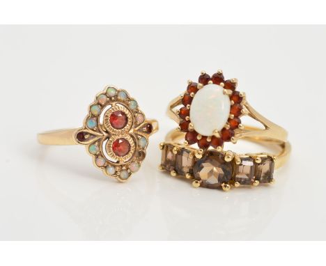 THREE 9CT GOLD GEM RINGS, the first a smokey quartz five stone ring, ring size P, the second designed as two central circular