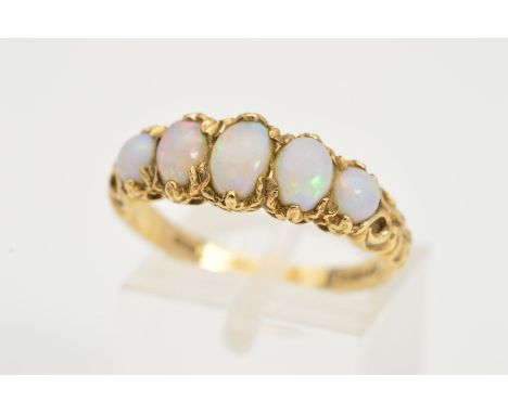 A 9CT GOLD FIVE STONE OPAL RING, designed as a graduated row of five opal cabochons within fancy claw settings to the scroll 