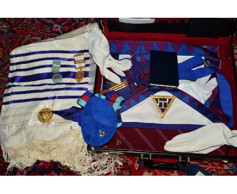 A BRIEFCASE CONTAINING MASONIC REGALIA, including apron, sash, medallions, skull cap, white gloves and books
