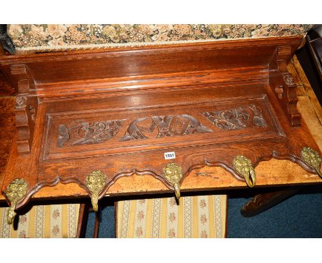 AN EARLY 20TH CENTURY CARVED OAK HANGING WALL SHELF with five brass hooks, width 99cm x height 42cm