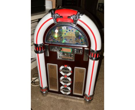 A RETRO WURLITZER JUKEBOX STYLE CABINET WITH A STEEPLETONE SPEAKER SYSTEM, in the rear and coloured flashing lights on the fr