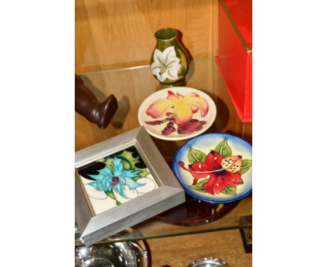 A FRAMED MOORCROFT PLAQUE, having Christmas thistle pattern measuring 10.5cm square, with two Moorcroft trinket dishes, one h