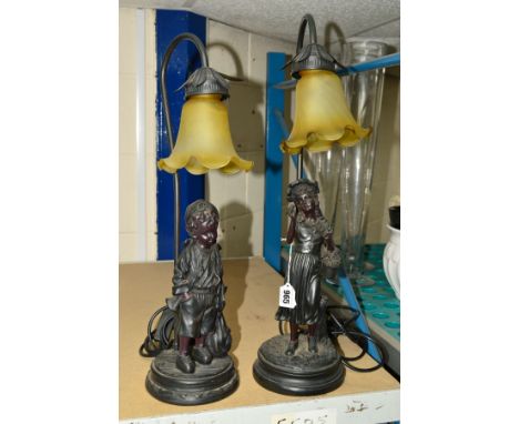 TWO FIGURAL TABLE LAMPS, in the form of a boy and a girl, both having lamp shades with fluted rim, total tallest height is 56