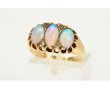 AN EDWARDIAN 18CT GOLD OPAL AND DIAMOND HALF HOOP RING, three oval opal cabochons measuring approximately 8.0mm x 5.00mm, fou