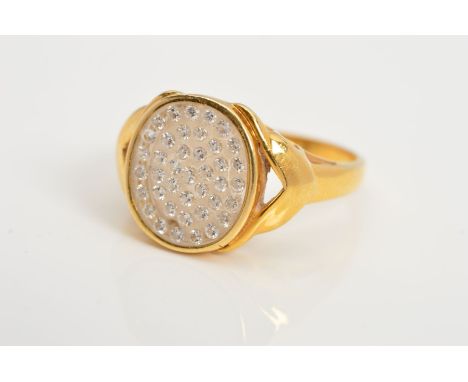 A GEM SET RING, of signet ring design, the oval glass panel set with circular colourless gems assessed as white sapphires to 