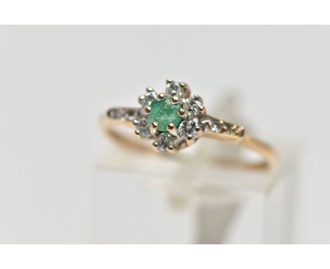 A 9CT GOLD EMERALD AND DIAMOND CLUSTER RING, set with a circular cut emerald, within a round brilliant cut diamond surround, 