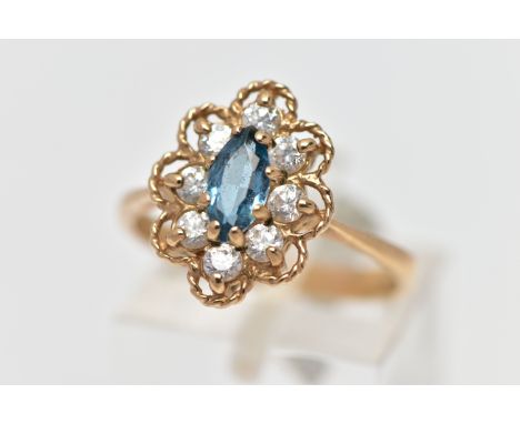 A 9CT GEM SET RING, the ring of a lozenge shape, set with a central marquise cut light blue synthetic spinel, within a surrou