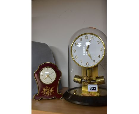 A BOXED JUNGHANS ATO 1000 DAY CLOCK AND A SWIZA MIGNON MUSICAL ALARM CLOCK, the Junghans clock under a glass dome, height 27c