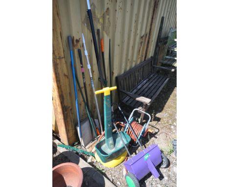 A SELECTION OF GARDEN HAND TOOLS, to include rakes, brushes, loppers, etc, along with a hose reel with pipe and two garden se