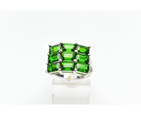 A 9CT WHITE GOLD CHROME DIOPSIDE DRESS RING, comprising nine rectangular cut chrome diopside, each within a claw setting, chr