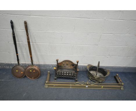 A SELECTION OF METALWARE, to include a cast iron fire grate, two fire grate fronts, a brass fender, two warming pans and a co