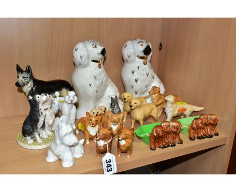 A GROUP OF SIXTEEN ASSORTED BESWICK DOG FIGURES AND A ROYAL DOULTON TERRIER, including two pipe trays with puppies, no.916, a