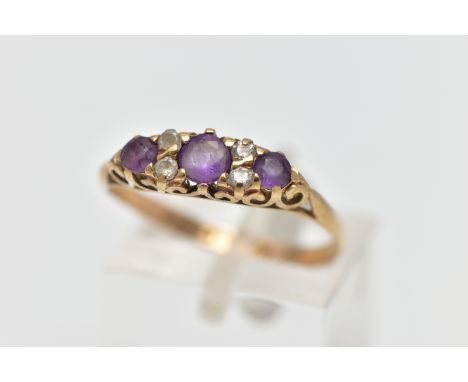 A 9CT GOLD AMETHYST AND CUBIC ZIRCONIA DRESS RING, the circular cut amethyst and similarly cut cubic zirconia duo spacers, to