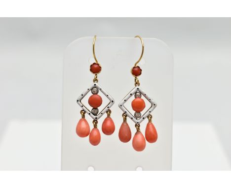 A PAIR OF ENAMEL, CORAL AND DIAMOND DROP EARRINGS, each earring is designed with a white enamel openwork diamond panel decora