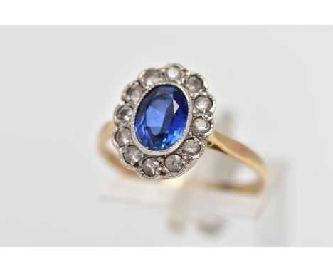 A 9CT GOLD SAPPHIRE AND CUBIC ZIRCONIA CLUSTER RING, the oval cut sapphire collet set, with circular cut cubic zirconia gem s