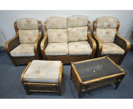 A FIVE PIECE WICKER CONSERVATORY SUITE, comprising a two seater sofa, a pair of armchairs, a pouffe, and a coffee table with 