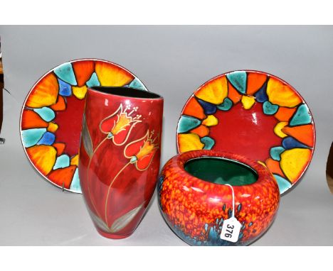 THREE PIECES OF POOLE POTTERY, comprising two Harlequin design shallow circular dishes, diameter 26.5cm, a Sunburst design co