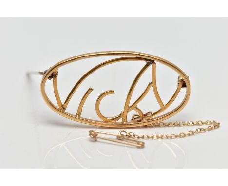 A YELLOW METAL OPENWORK BROOCH, openwork 'Vicky' name brooch, approximate dimensions length 43mm x width 22mm, unmarked, fitt