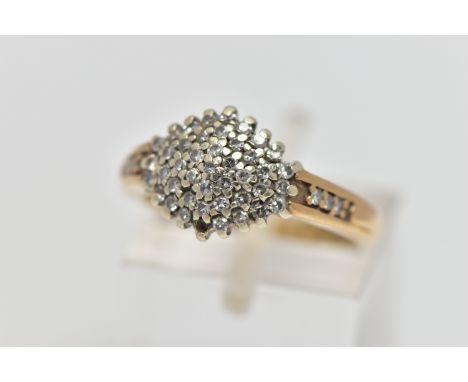 A 9CT GOLD DIAMOND CLUSTER RING, of a marquise form set with single cut diamonds, single cut diamond set shoulders, polished 