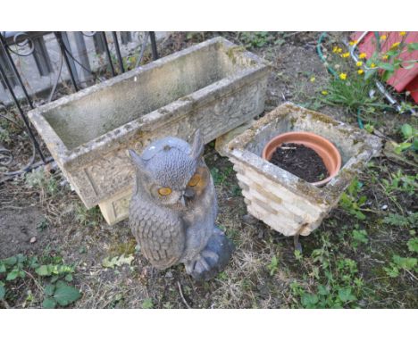 A RECTANGULAR COMPOSITE GARDEN PLANTER, on a pair of plinths, length 71cm, along with a square tapered brick effect planter, 