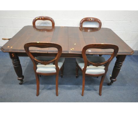 A VICTORIAN MAHOGANY WIND OUT DINING TABLE, with canted corners, two additional leaves, on fluted legs, and ceramic casters, 